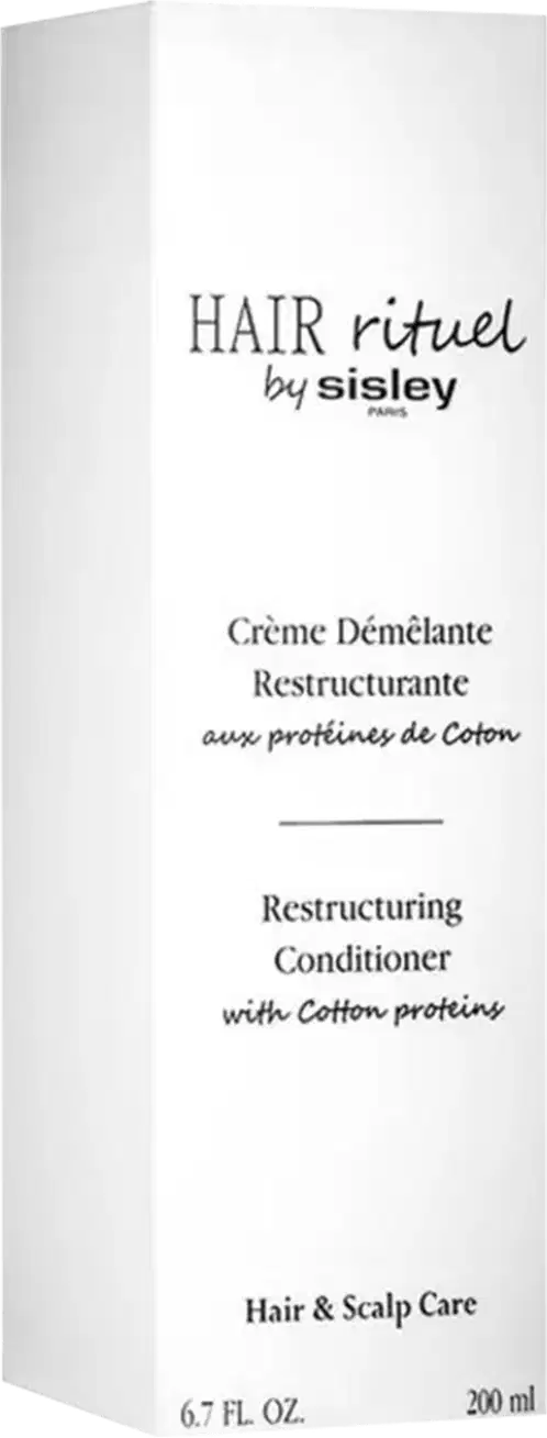 Embalagem branca retangular com texto "HAIR rituel by sisley" em preto. Rótulo com título "Crème Démélante Restructurante" e informações sobre o produto em francês e inglês. Embalagem de item de perfumaria para cuidados com o cabelo.