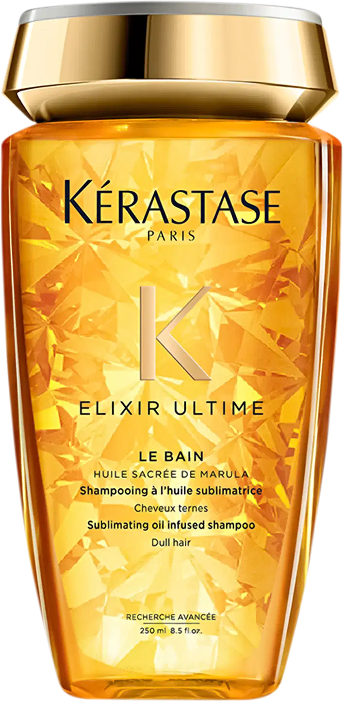Frasco de shampoo da marca Kérastase Paris, com design dourado e rótulo destacando o nome "Elixir Ultime" e a descrição "Shampooing à l'huile sublimatrice", indicando um shampoo com óleo sublimador. O frasco possui 250 ml de capacidade.