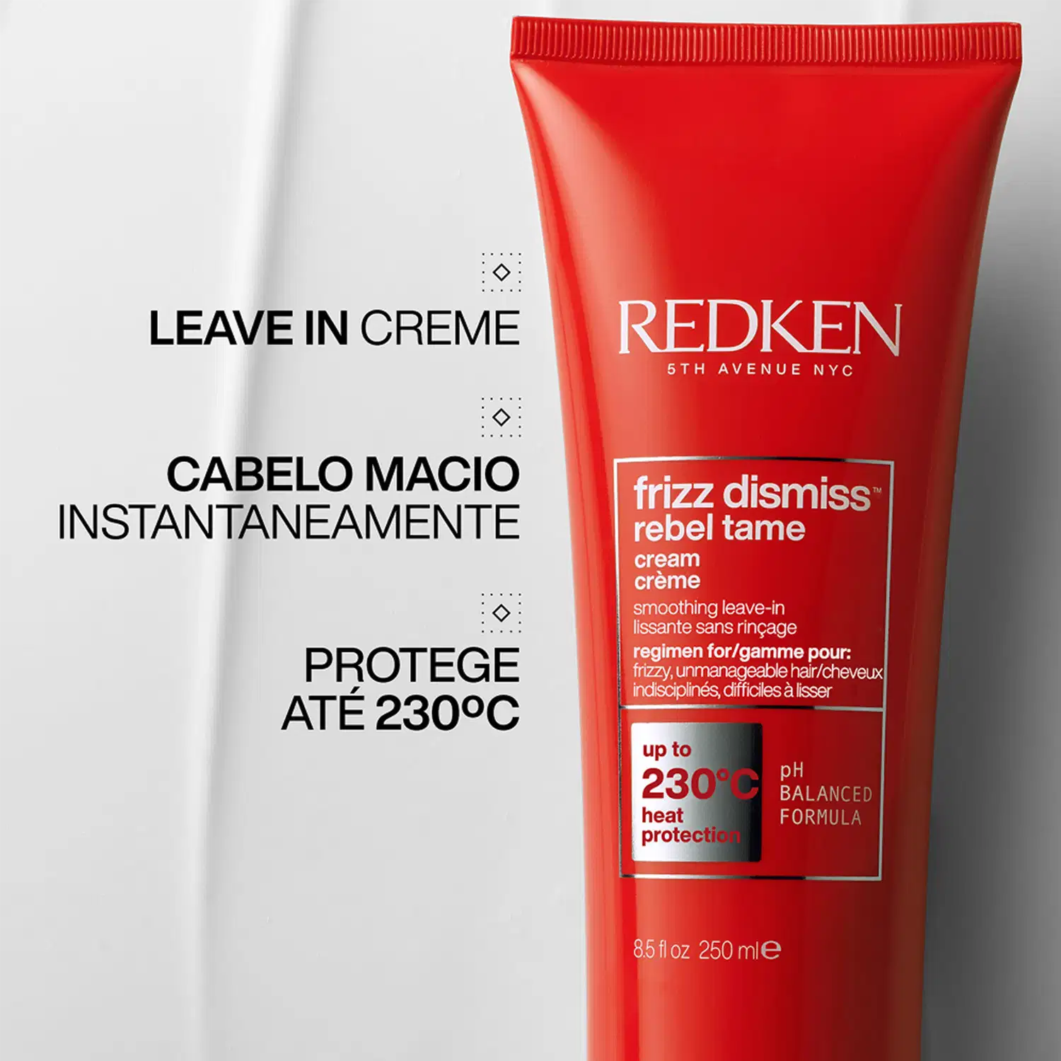 Embalagem vermelha de produto de beleza da marca Redken, com o texto "Frizz Dismiss Rebel Tame Cream" e informações sobre proteção térmica até 230°C.