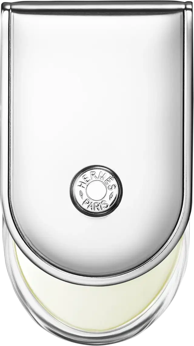 Frasco de perfume Hermès em vidro transparente com tampa arredondada. Rótulo circular com a marca Hermès Paris impresso em preto. Líquido incolor visível no interior do frasco.