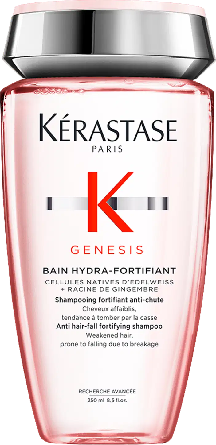 Frasco de shampoo da marca Kérastase Paris, da linha Genesis, com embalagem rosa e prata. O rótulo apresenta o nome da marca, da linha e informações sobre o produto, que é um shampoo fortificante anti-queda.