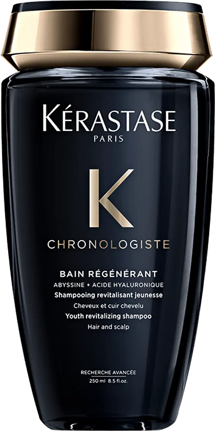 Frasco preto e dourado da linha Chronologiste da Kérastase, contendo um shampoo revitalizante para cabelos e couro cabeludo, com fórmula à base de abissina e ácido hialurônico.