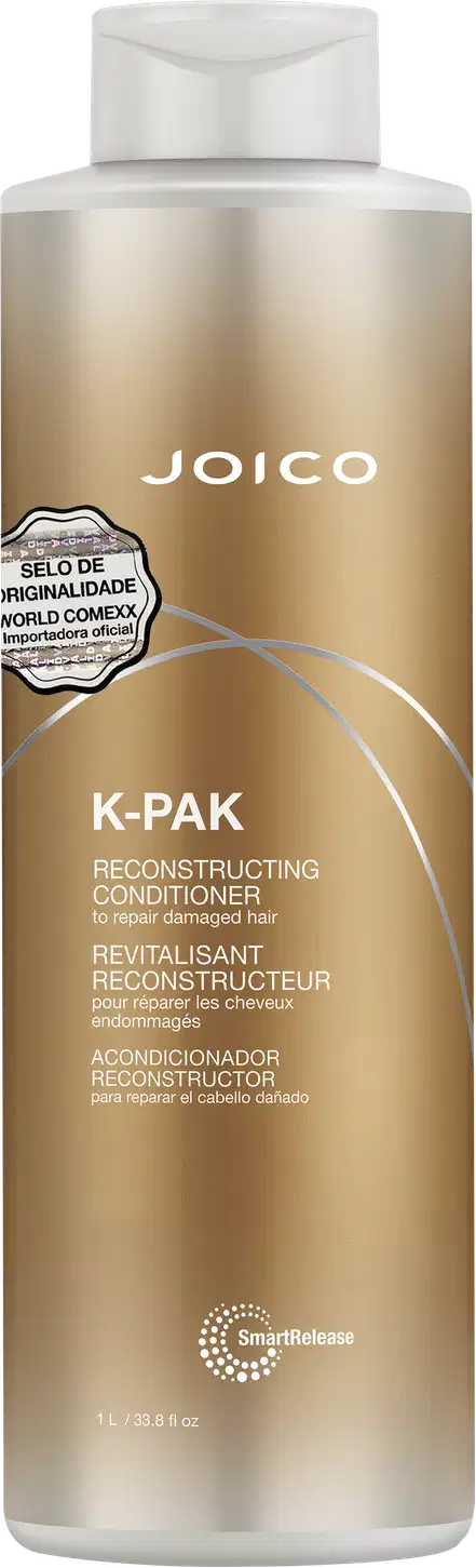 Frasco de condicionador de 1 Litro da marca Joico, da linha K-Pak, com embalagem em tons dourados e brancos. O rótulo destaca o "Selo de Originalidade World Comexx" e a função de reconstrução do produto.