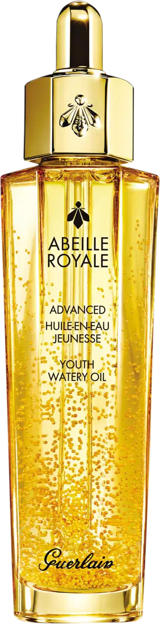A imagem mostra o frasco do óleo hidratante Abeille Royale da Guerlain. É um frasco de vidro transparente contendo um líquido dourado brilhante, tem um formato cilíndrico alongado com uma tampa dourada na parte superior, com uma abelha estampada.