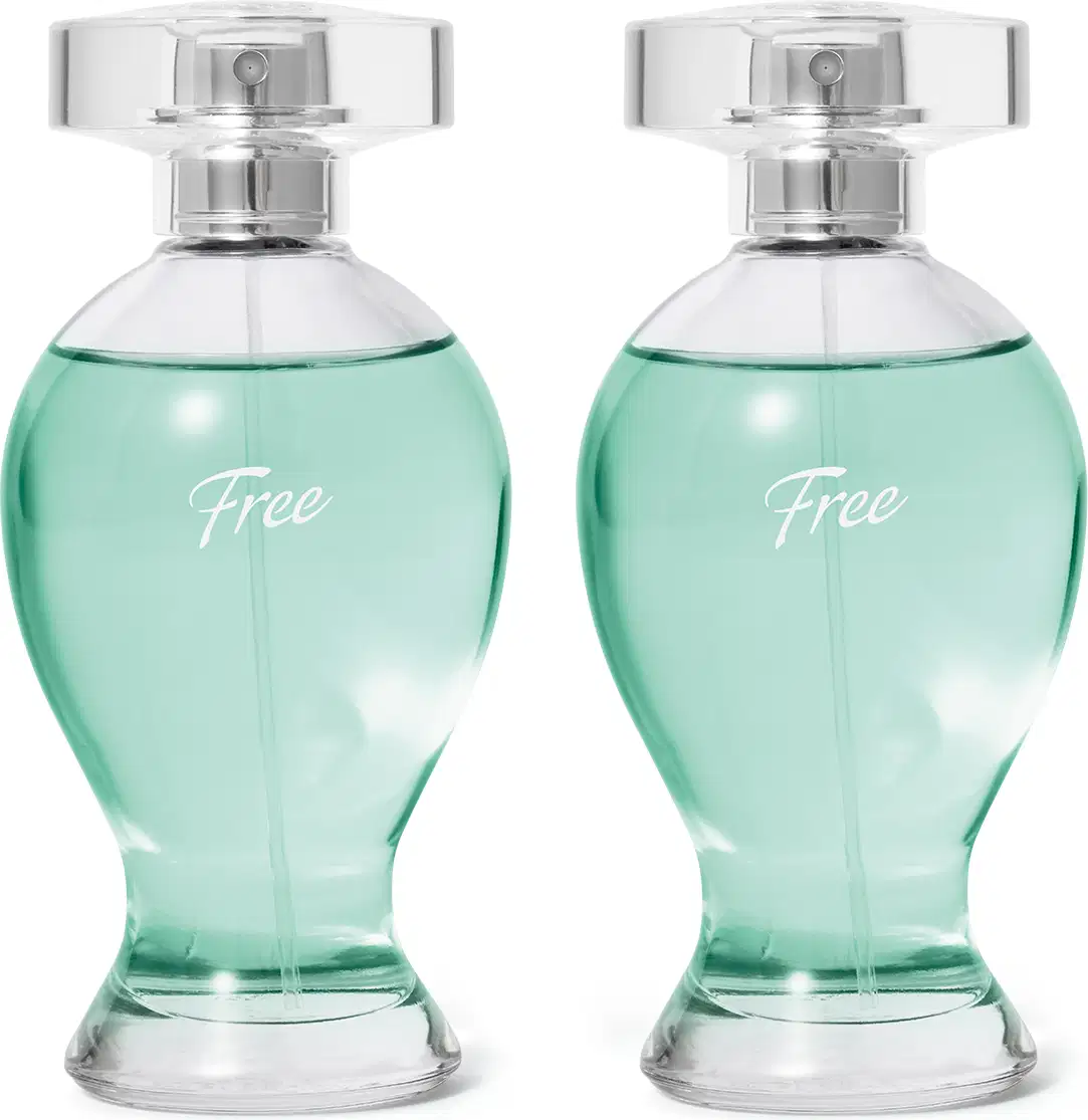 Dois frascos transparentes em formatos curvilíneos com líquidos azuis, pulverizadores prateados e tampas transparentes contendo desodorante colônia Boticollection Free.