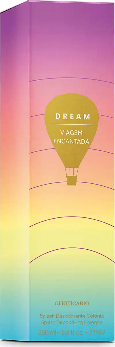 Imagem de embalagem retangular em tons de roxo, rosa e amarelo com ilustração de balão de ar quente e texto "Dream Viagem Encantada" em destaque. Contém um frasco de 200 ml de body splash.