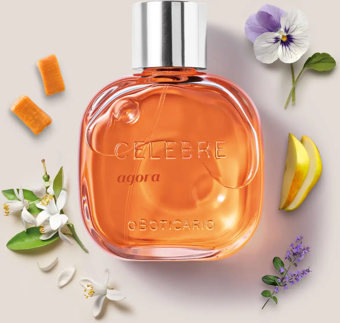 Frasco de vidro transparente com líquido laranja, tampa prateada e letras pretas e em relevo contendo de desodorante colônia Celebre Agora Feminino, rodeado por caramelos, violeta, flor de laranjeira e peras frescas.
