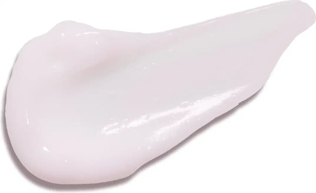 Textura branca, brilhante e cremosa de creme hidratante para mãos Cuide-se Bem Rosa e Algodão em superfície lisa.