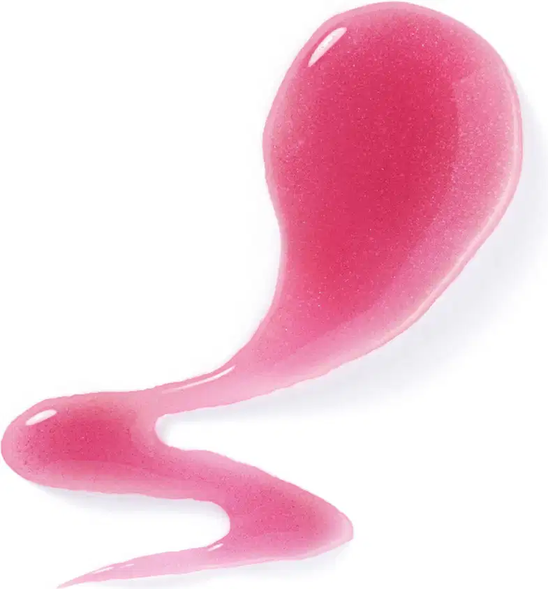 Textura rosada e brilhante do sabonete líquido perfumado espalhada sobre superfície branca formando um pequeno rastro de produto.