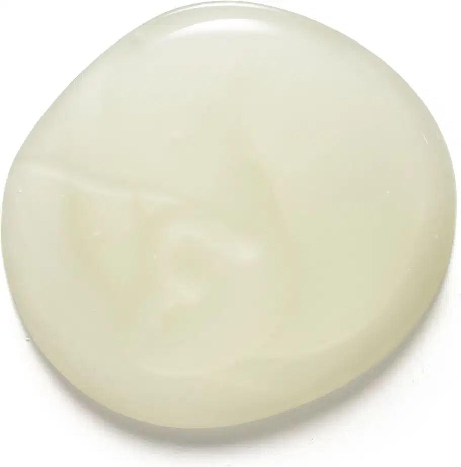 Textura gelatinosa, brilhante de cor branca do shampoo Match Oleosidade Controlada. Tem aparência fluída e uniforme, espalhada sobre superfície branca e lisa.