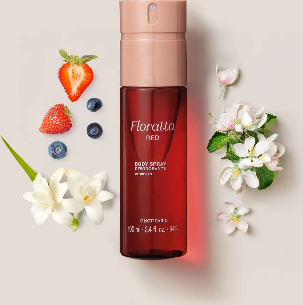Frasco cilíndrico de body spray na cor vermelha com tampa borrifadora rosa da marca Floratta Red cercado por flores brancas de baunilha e frutas vermelhas, como morangos e mirtilos.