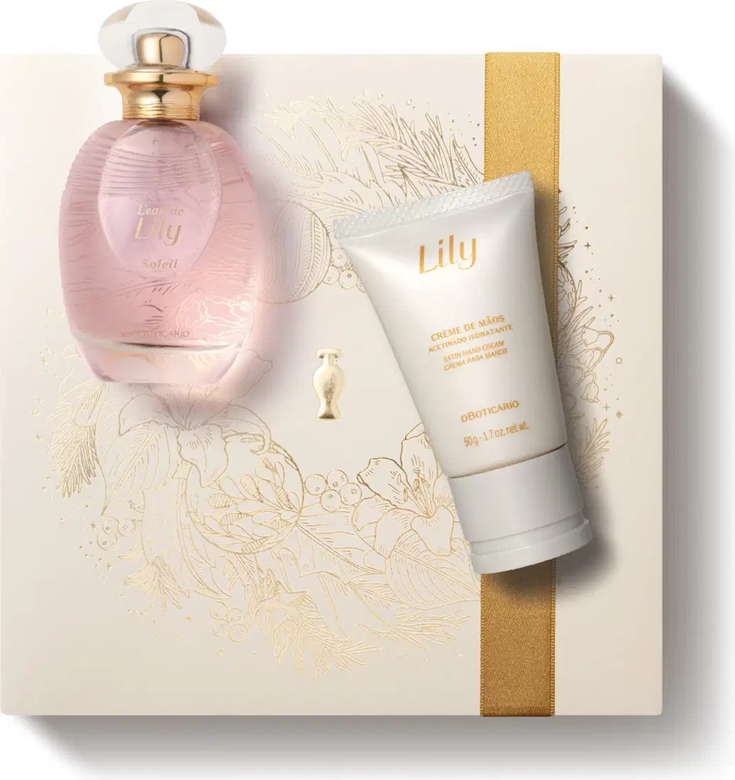 Imagem do Kit Presente Natal Lily Soleil com um vidro transparente e líquido rosa de desodorante colônia e uma bisnaga branca com letras douradas de creme acetinado para as mãos sobre uma caixa presenteável rosa-claro com estampa floral.