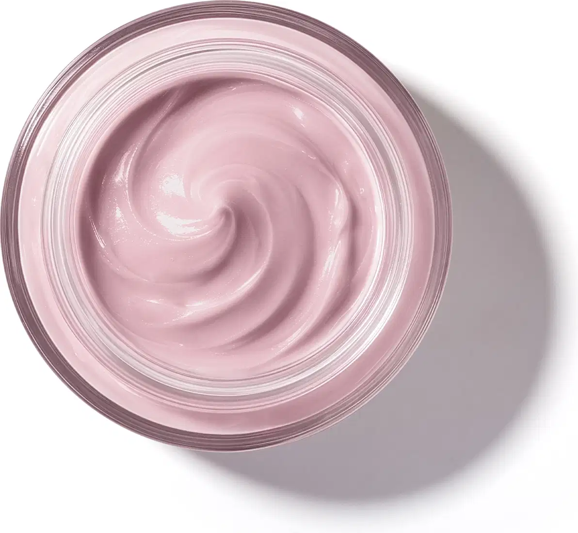 Pote de vidro visto de cima com foco na textura do creme com padrão de espiral suave de textura cremosa e brilhante em tom de rosa claro.