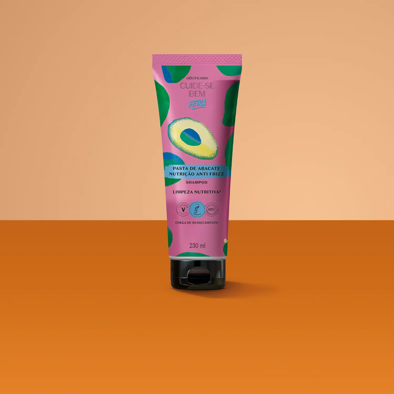 Imagem de tubo de shampoo da marca Cuide-se bem Feira Pasta de Abacate, em fundo rosa e vermelho. A embalagem é na cor roxa com ilustrações de abacate.
