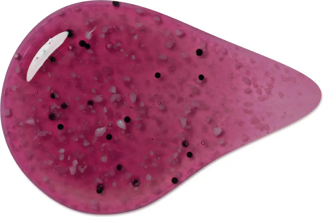 Textura arroxeada, brilhante e granulada de item de sabonete esfoliante corporal, com pequenos pontos.