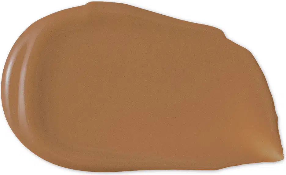 O produto de beleza apresenta uma textura cremosa e uniforme, com uma coloração marrom clara e brilho suave, sugerindo uma consistência macia e aveludada.