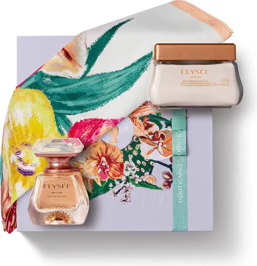 Imagem do kit de presente Elysée, trazendo a elegante fragrância da marca, com borrifador dourado e tampa transparente e um pote também de vidro com tampa dourada contendo creme hidratante corporal. Há também uma caixa branca com ilustrações florais.