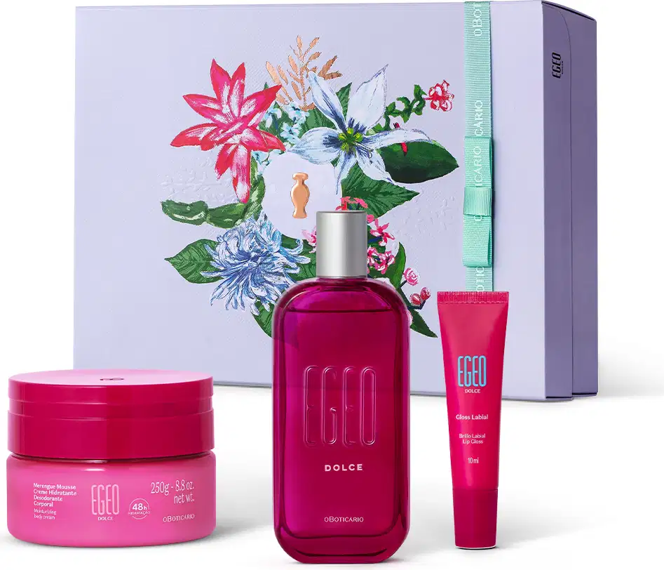 Imagem do kit presente Egeo Dolce com creme hidratante corporal, desodorante colônia com tampa prateada, bisnaga de gloss labial e caixa branca com ilustração floral. As embalagens são em tons de rosa com rótulos em letras brancas.