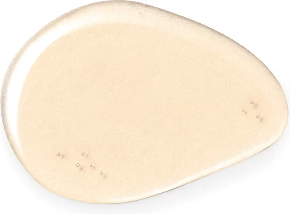 Textura líquida e transparente de item de cuidados de corpo e banho em tom rosa claro, com pequenas bolhas visíveis na superfície.