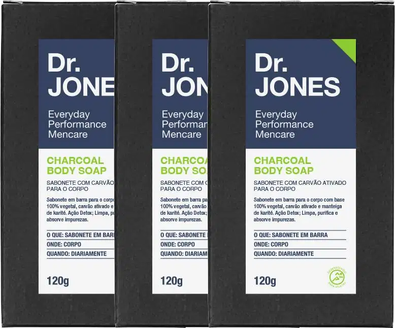 A imagem mostra três sabonetes corporais Dr. Jones. Os sabonetes são pretos, são feitos de carvão ativado e possuem uma embalagem azul e verde de 120g.