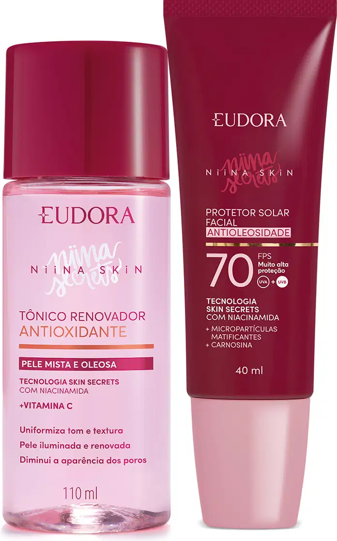 A imagem mostra um kit com dois produtos, lado a lado. Na esquerda, um frasco plástico transparente rosa com tampa vermelha, ao lado de um protetor solar com embalagem toda vermelha e tampa rosa claro.