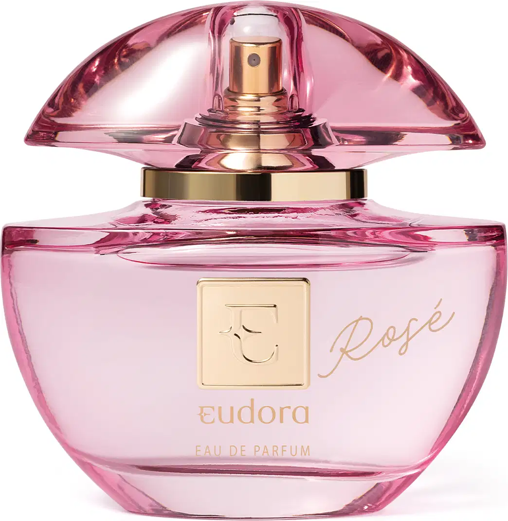 Frasco do Eau de Parfum Eudora Rosé. O frasco é feito de vidro rosa com detalhes em dourado. Na parte frontal, está gravado o nome "Rosé" em letras douradas cursivas. O topo do frasco tem uma tampa em vidro que deixa entrever a parte dourada do borrifador