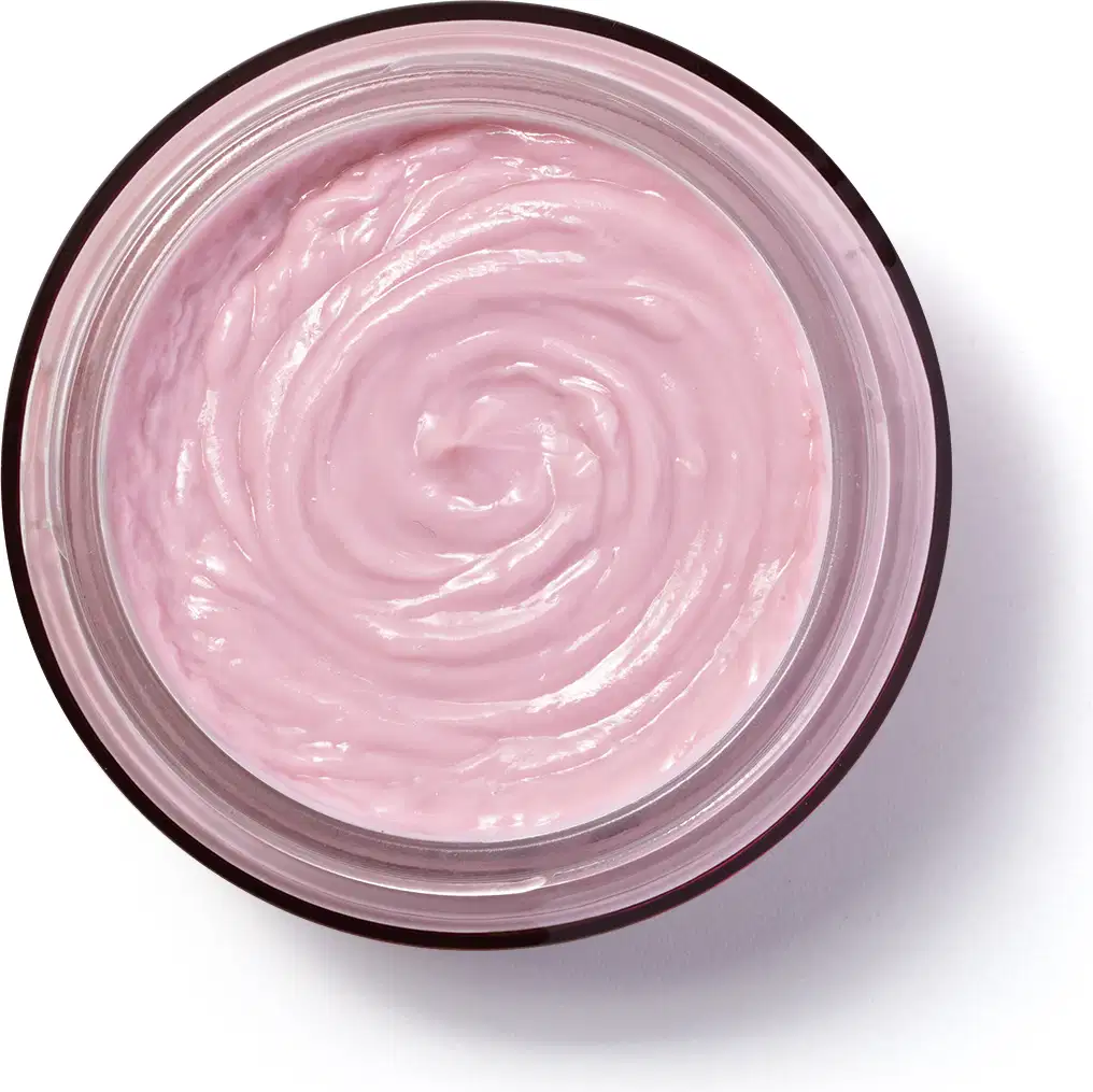A imagem mostra a embalagem de vidro do hidratante Eudora Rosé vista de cima. O produto tem uma textura cremosa e espiral bem definida na cor rosada. Visto de cima, a embalagem é circular.