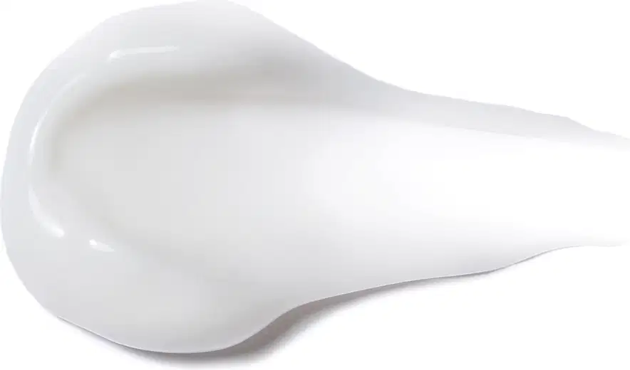 Textura do produto Creme para Pentear - Definição. Possui uma forma arredondada e suave, com uma superfície lisa e brilhante, em uma tonalidade branca. Não há rótulos ou textos visíveis na imagem, apenas a forma do produto em si.