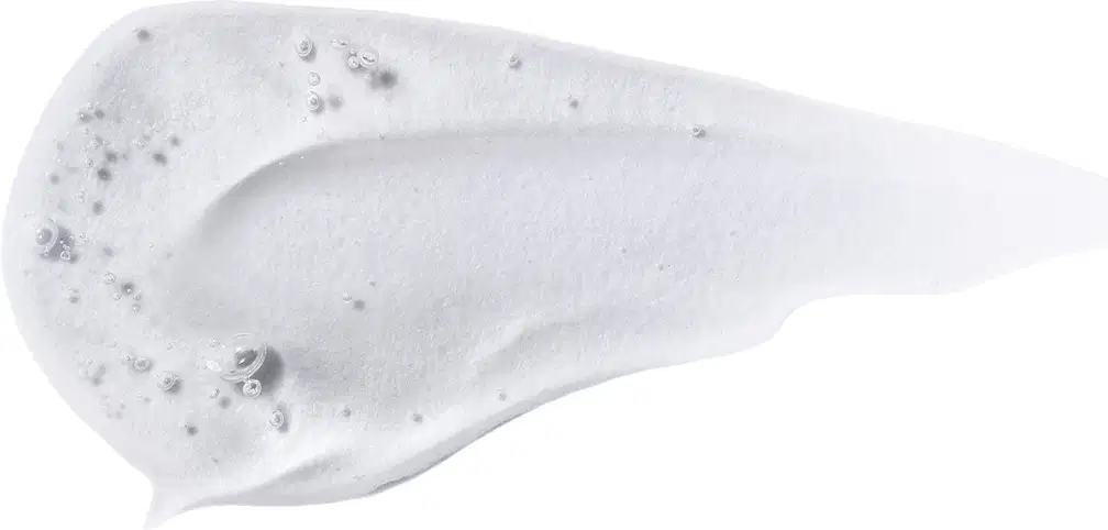 Textura do produto Finalizador Crono Jelly. Possui uma forma alongada e curva, com uma superfície branca e textura aveludada, com pequenas bolhas ou pontos visíveis. Não há rótulos ou textos visíveis na imagem.