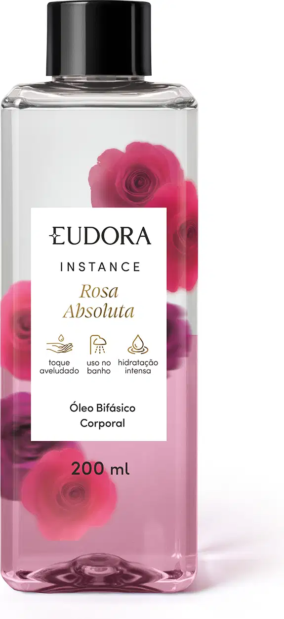 O produto apresentado é um óleo bifásico corporal da linha Instance Rosa Absoluta. O frasco é transparente, com um rótulo branco contendo o nome da marca, da linha e do aroma. A embalagem possui uma tampa preta e contém 200 ml do produto.