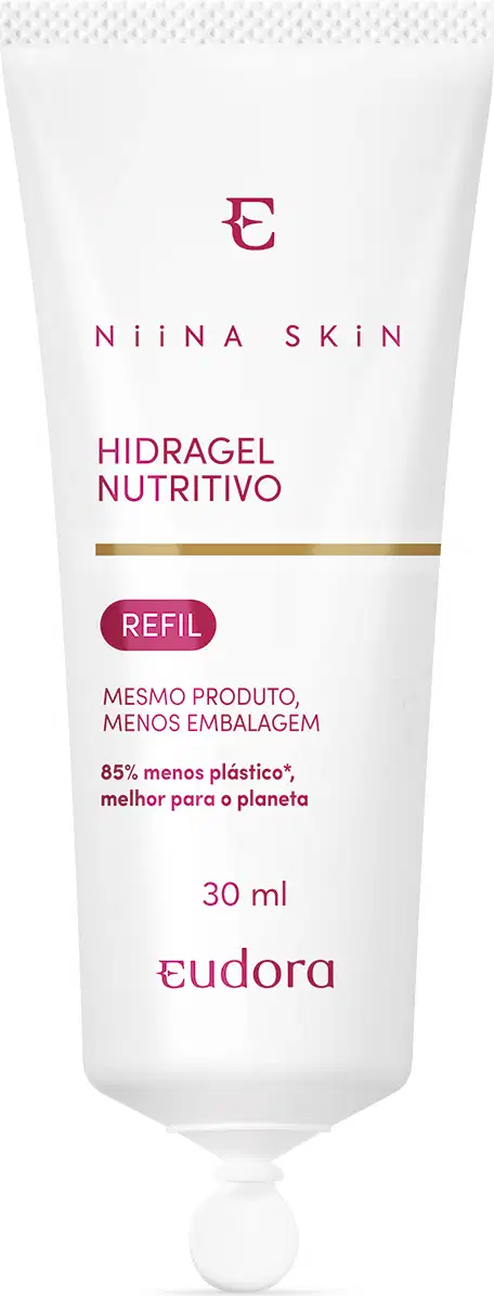Embalagem plástica branca opaca em formato de tubo, com 30ml. Tampa na parte inferior e formato redondo, semi-gota, achatado. Rótulo com texto em rosa. Logotipo e nome da marca na parte inferior. Cores predominantes são branco, vermelho e dourado.