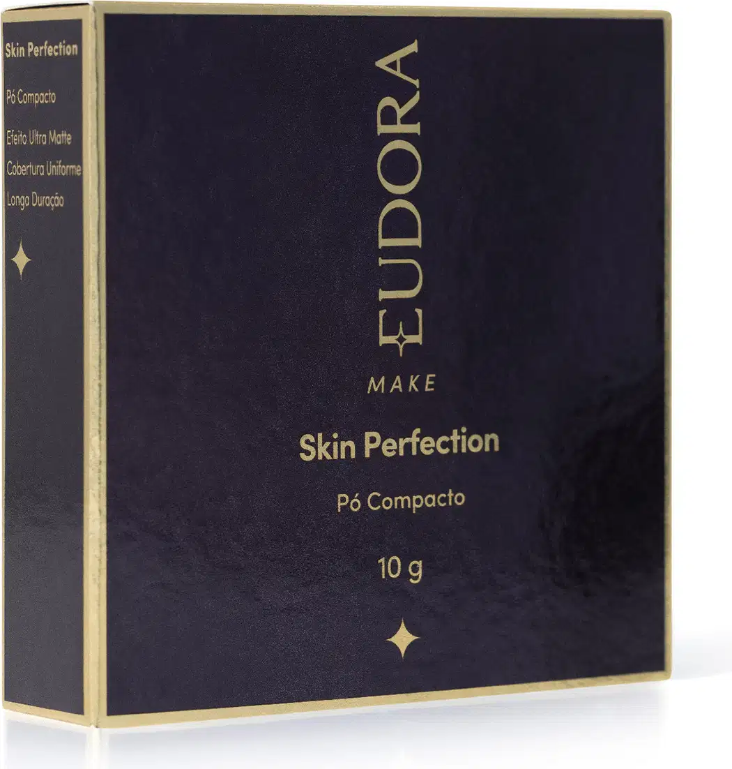 Caixa preta e dourada de pó compacto da marca Eudora Make, com texto "Skin Perfection" e informações sobre o produto.
