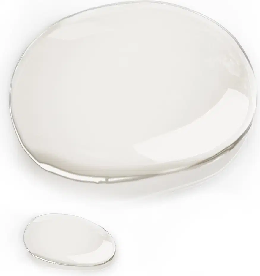 Textura do produto, em uma forma arredondada e transparente. Com uma consistência líquida.