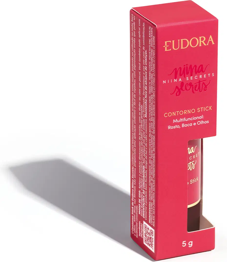 A embalagem do Contorno Stick é uma caixa rosa com o nome da marca e da linha impressos em dourado. O produto em si é um bastão de maquiagem com uma tampa protetora.