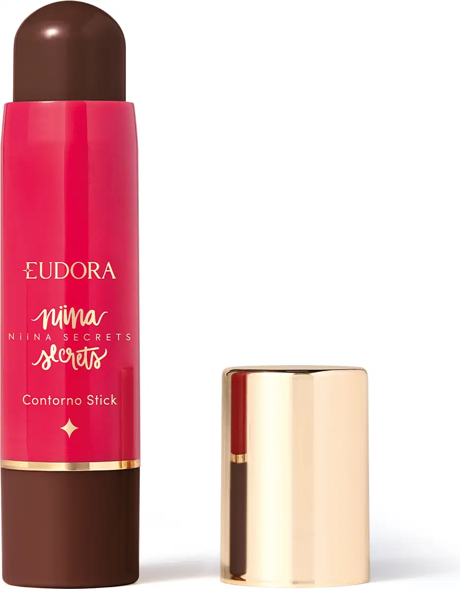 O produto apresentado é um contorno em bastão da linha Niina Secrets. A embalagem é cilíndrica e de cor rosa vibrante, com o nome da marca e da linha impressos em letras douradas. A embalagem também possui um detalhe dourado na parte superior.