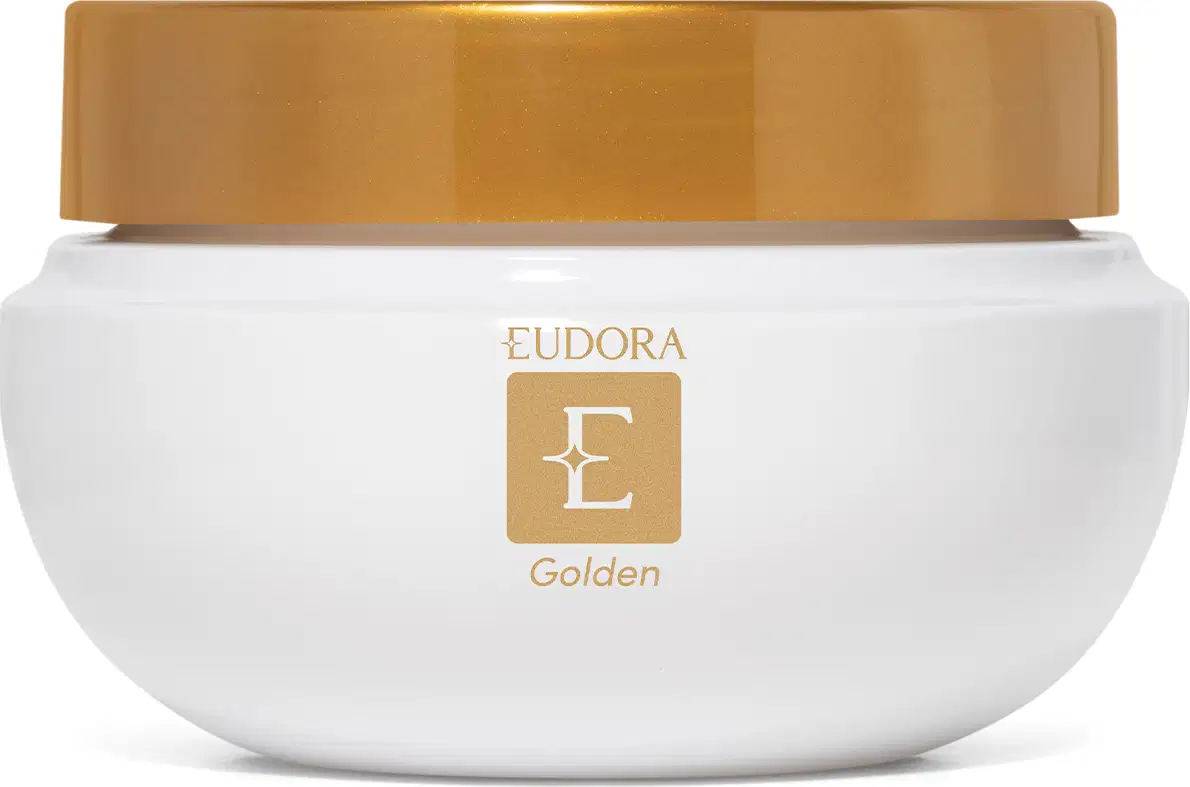 Frasco de creme hidratante branco com tampa dourada, exibindo o logotipo da marca Eudora Golden. O produto apresenta uma embalagem simples e elegante, com destaque para a cor dourada da tampa.