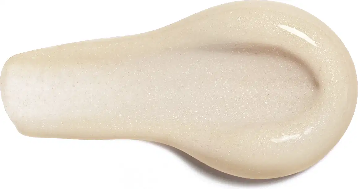 A imagem apresentada é da textura da Loção Hidratante Diva Suprema, em formato de gota, com uma superfície lisa e brilhante em tons de bege.