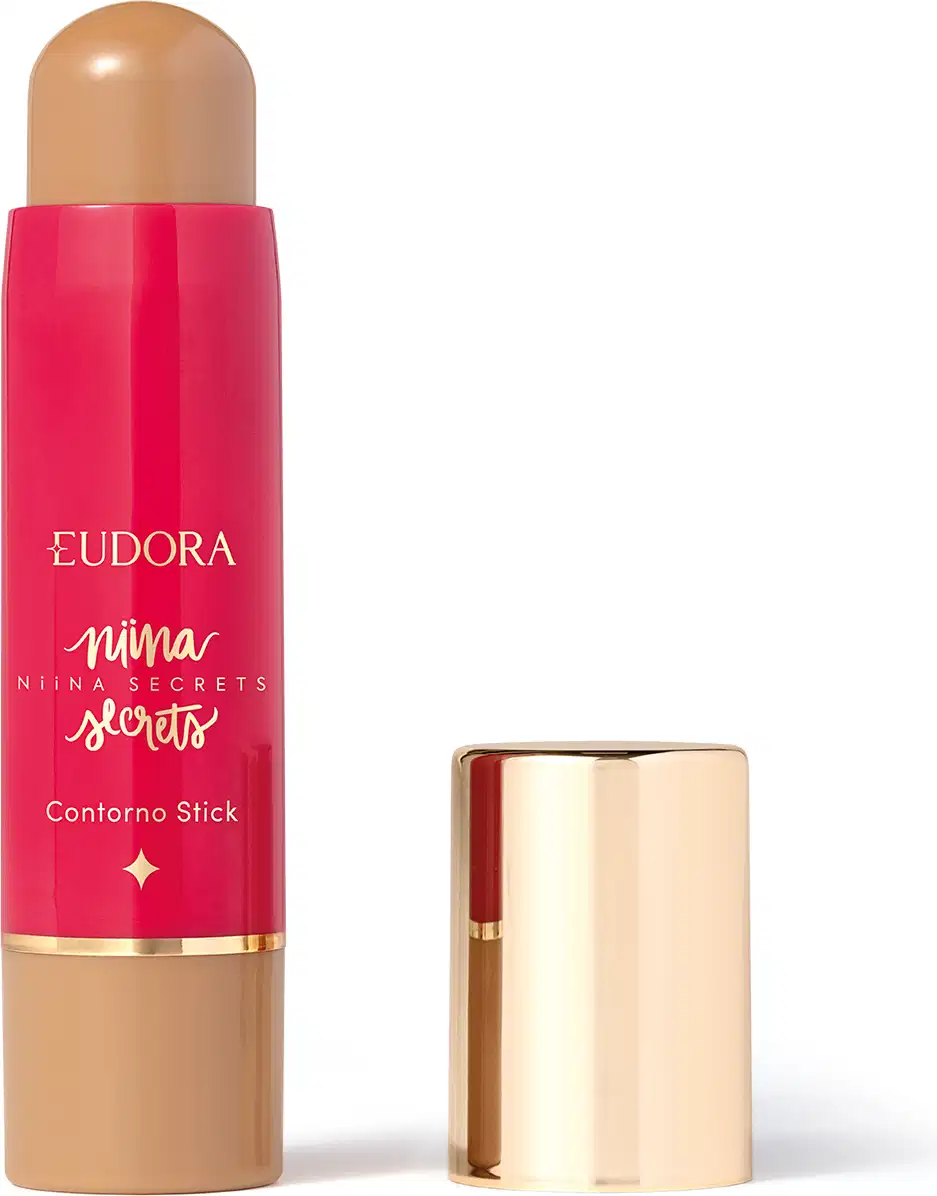 O produto apresentado é um contorno em bastão da linha Niina Secrets. A embalagem é cilíndrica e de cor rosa vibrante, com o nome da marca e da linha impressos em letras douradas. A embalagem também possui um detalhe dourado na parte superior.