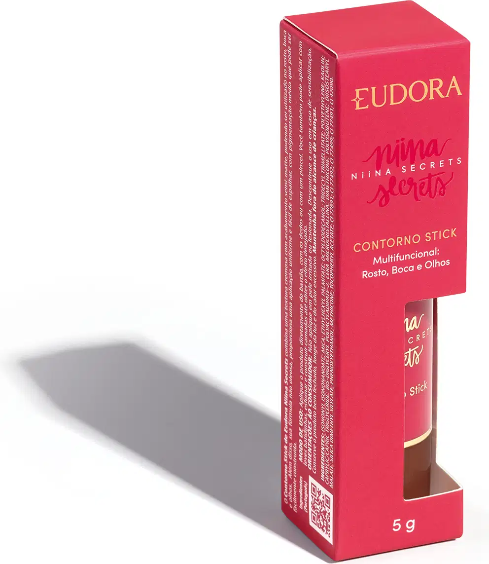 A embalagem do Contorno Stick é uma caixa rosa com o nome da marca e da linha impressos em dourado. O produto em si é um bastão de maquiagem com uma tampa protetora.