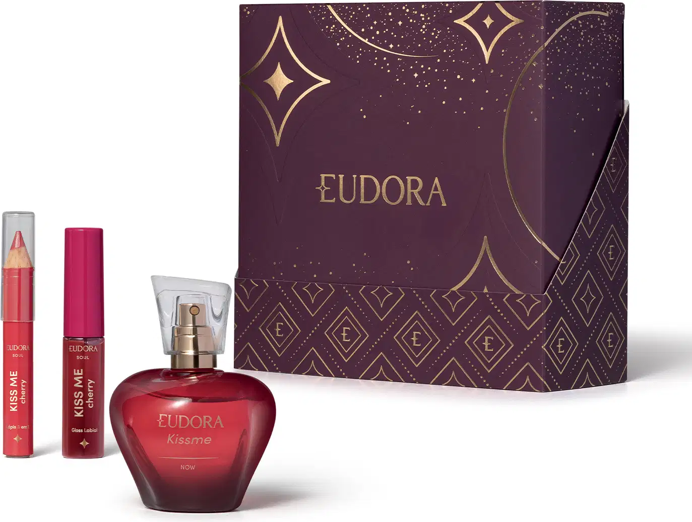Conjunto de produtos da marca Eudora: Desodorante Colônia KissMe, o Gloss Labial e o Lápis Multifuncional na cor Cherry. Com uma caixa decorada com padrões dourados e estrelas em fundo roxo escuro, indicando ser um kit presente dia dos namorados.