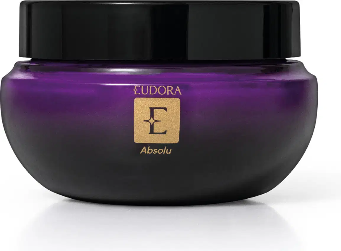 Frasco de item de cuidados corporais da marca Eudora, na cor roxa com tampa preta, com rótulo dourado contendo a palavra "Absolu".