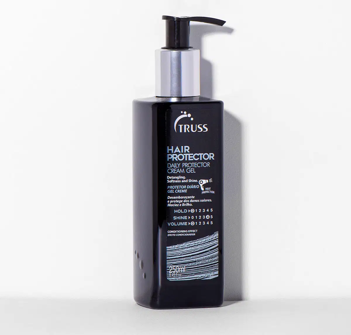 A imagem mostra um frasco de produto capilar da marca Truss: "Hair Protector" que desembaraça, protege dos danos solares e deixa um brilho natural.