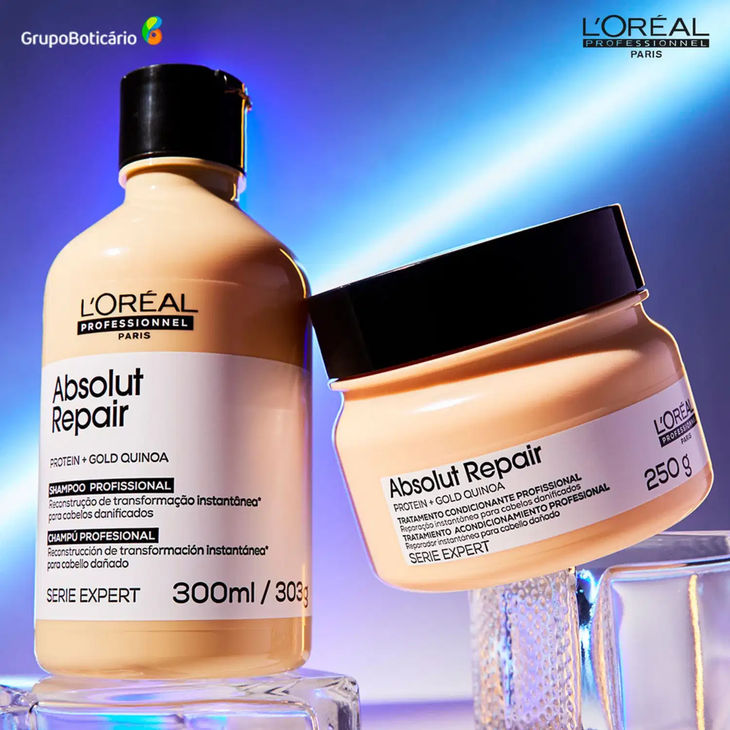 A imagem mostra dois produtos de cuidados capilares da linha L'Oréal Professionnel Absolut Repair. Um é um shampoo. O outro é uma máscara capilar em um pote plástico bege preto de 250g.
