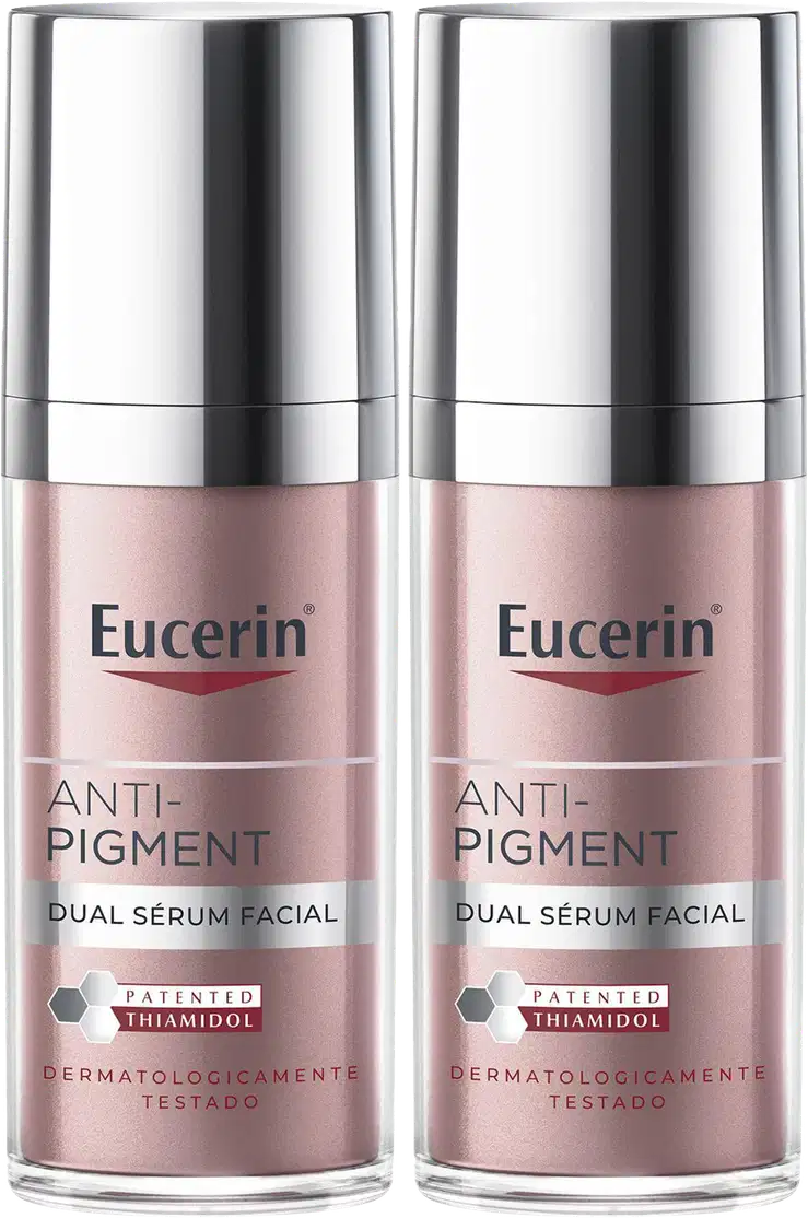 Dois frascos de serum facial Anti-Pigment da marca Eucerin, com embalagem prateada e rosa, apresentando o texto "Anti-Pigment Dual Sérum Facial" e o logotipo da marca.