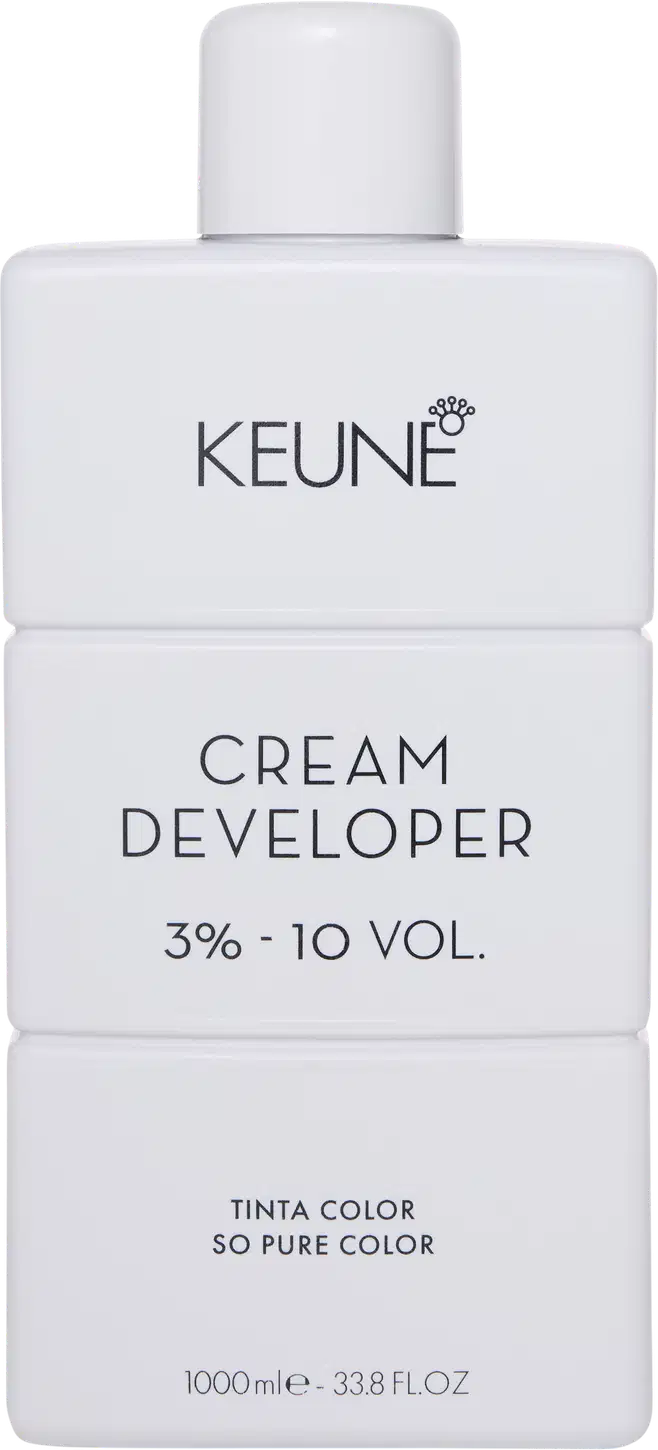 Frasco branco da marca Keune, contendo Cream Developer com 3% - 10 VOL. O rótulo apresenta o nome da marca e do produto em letras pretas.