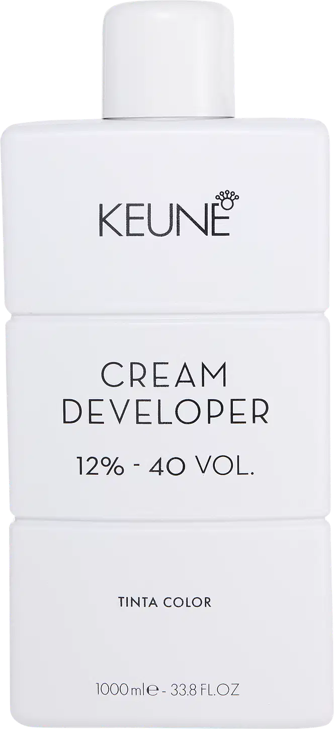 Frasco branco da marca Keune, contendo Cream Developer com 12% - 40 VOL. O rótulo apresenta o nome da marca e do produto em letras pretas.