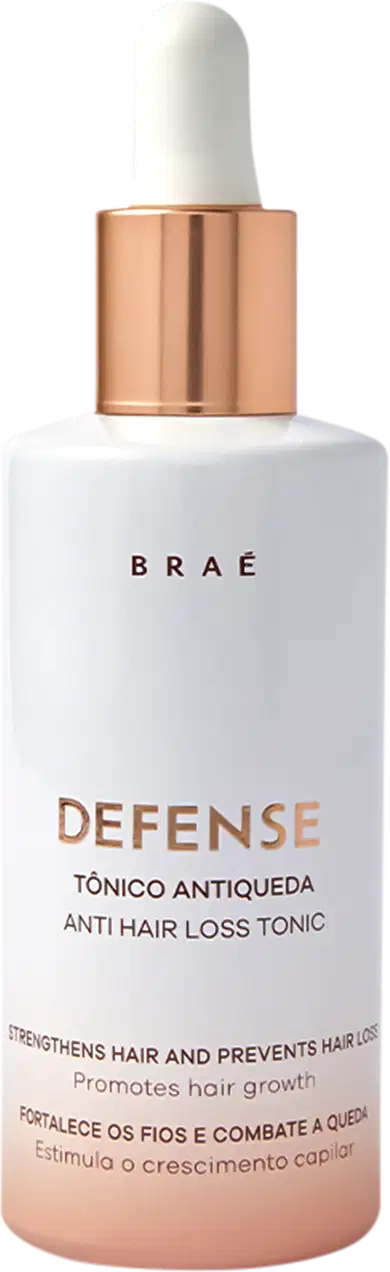 Um frasco de Tônico Antiqueda Defense da Braé, com rótulo branco e tampa cobre. O texto afirma fortalecer o cabelo, prevenir a queda capilar e promover o crescimento capilar.