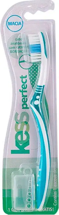 Escova dental Kess Perfect, embalagem plástica transparente, com cabo e cabeça em tons de azul e verde, rótulo com marca "Kess" e informações sobre o produto.