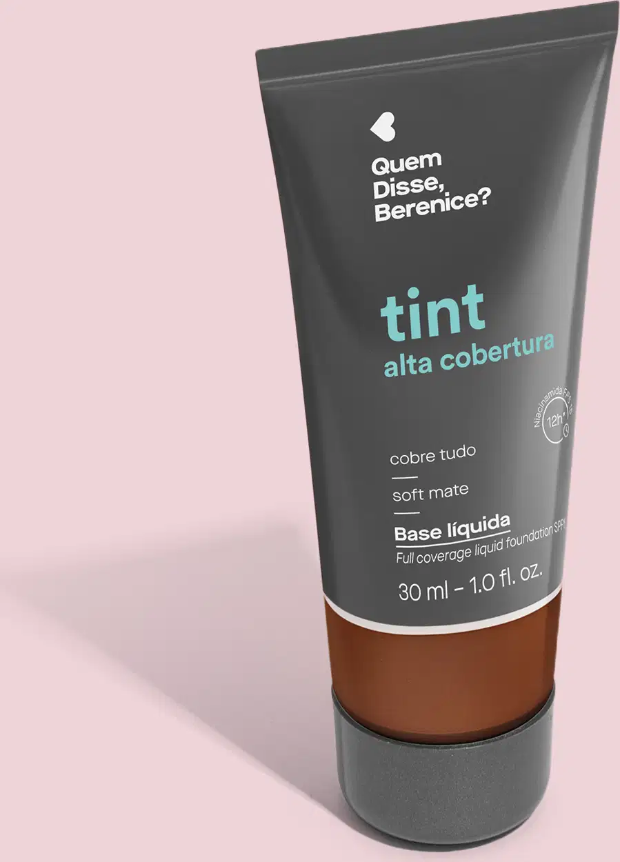 A imagem mostra a Base Tint Alta Cobertura da Quem Disse, Berenice? Embalagem preta com parte inferior transparente para mostrar a cor. O texto com nome e benefícios do produto aparece em letras brancas e em turquesa sobre fundo preto.