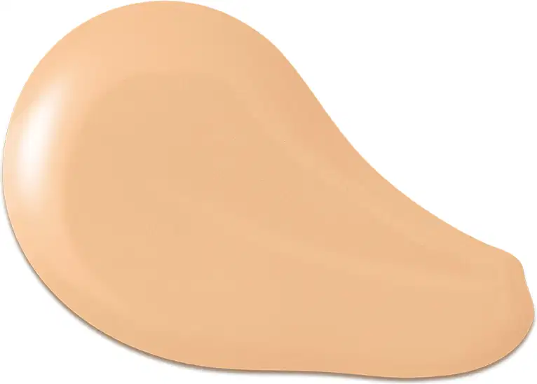 O produto apresentado na imagem é uma base de maquiagem de cor bege, com uma textura cremosa e suave. Sua forma é arredondada e convexa. Não há rótulos, marcas ou outras informações visíveis na imagem.